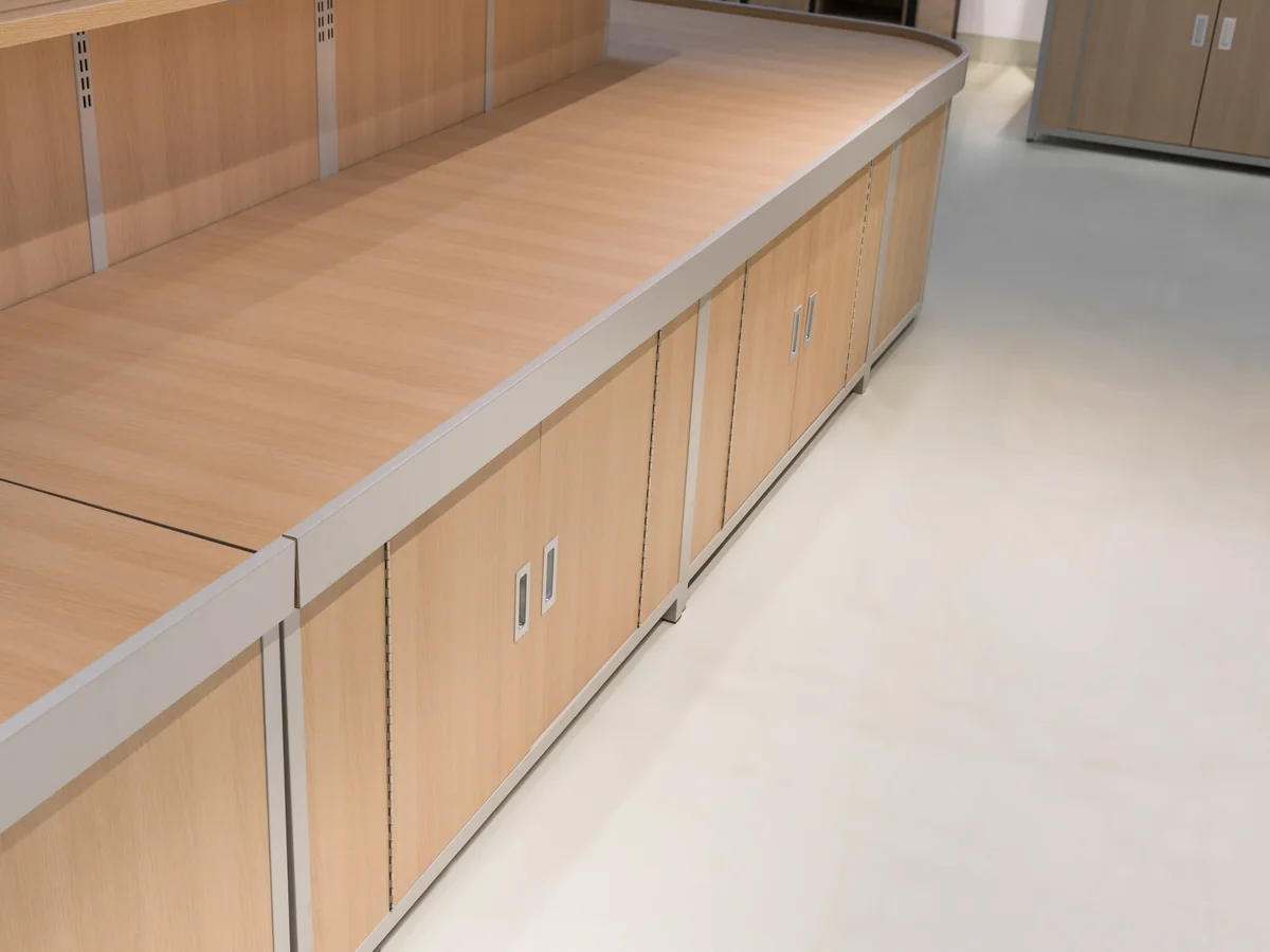Close-up of the cabinet run showing the pale plinth along the base