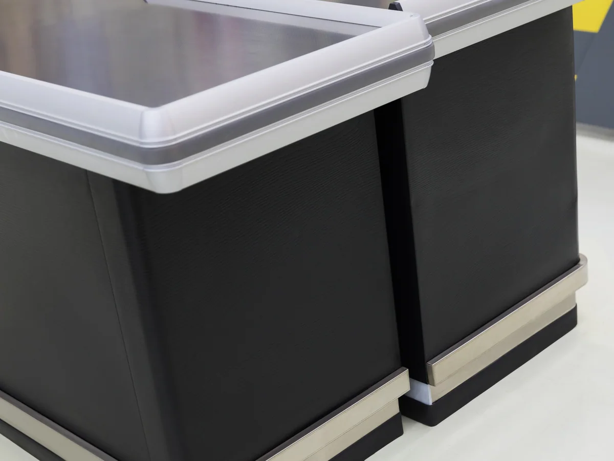 Close-up of the charcoal body panel meeting the stainless top