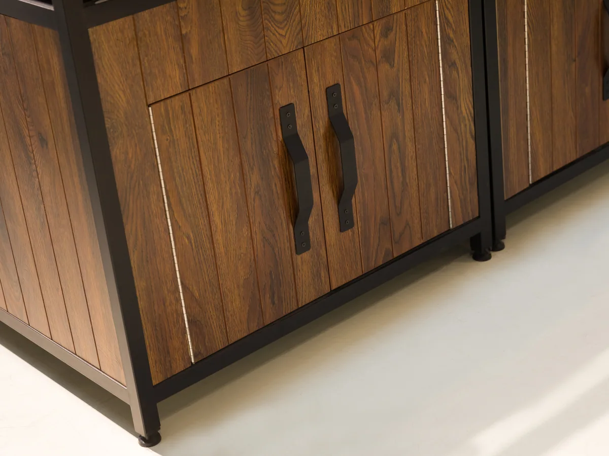 Close-up of the dark timber cabinet doors with long black bar handles