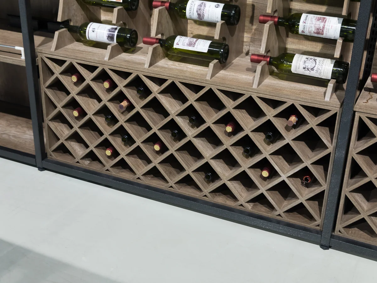 Close-up of the diamond lattice bottle storage at the base of the wall