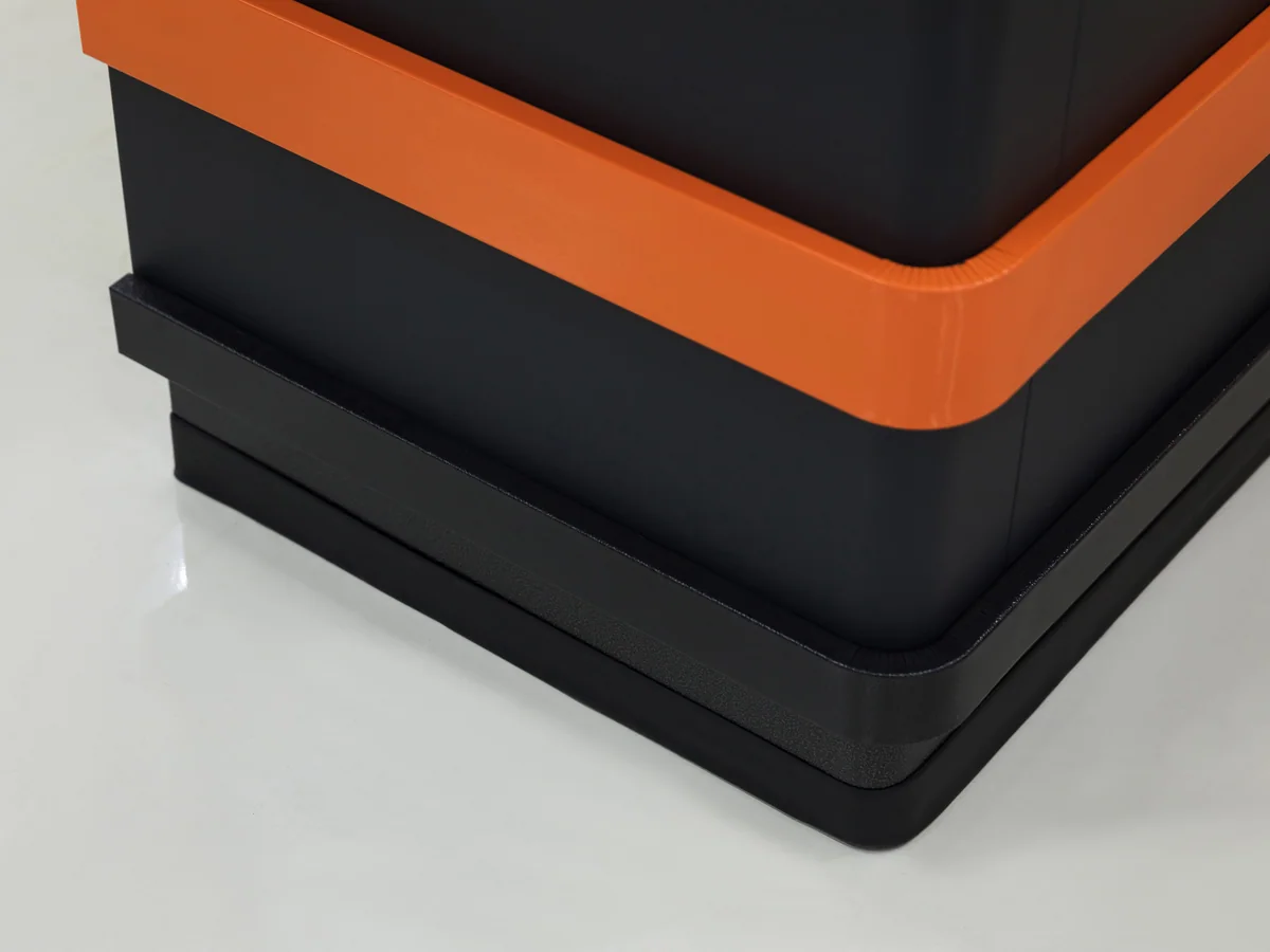 Close-up of the edge where the bright band meets the charcoal panel