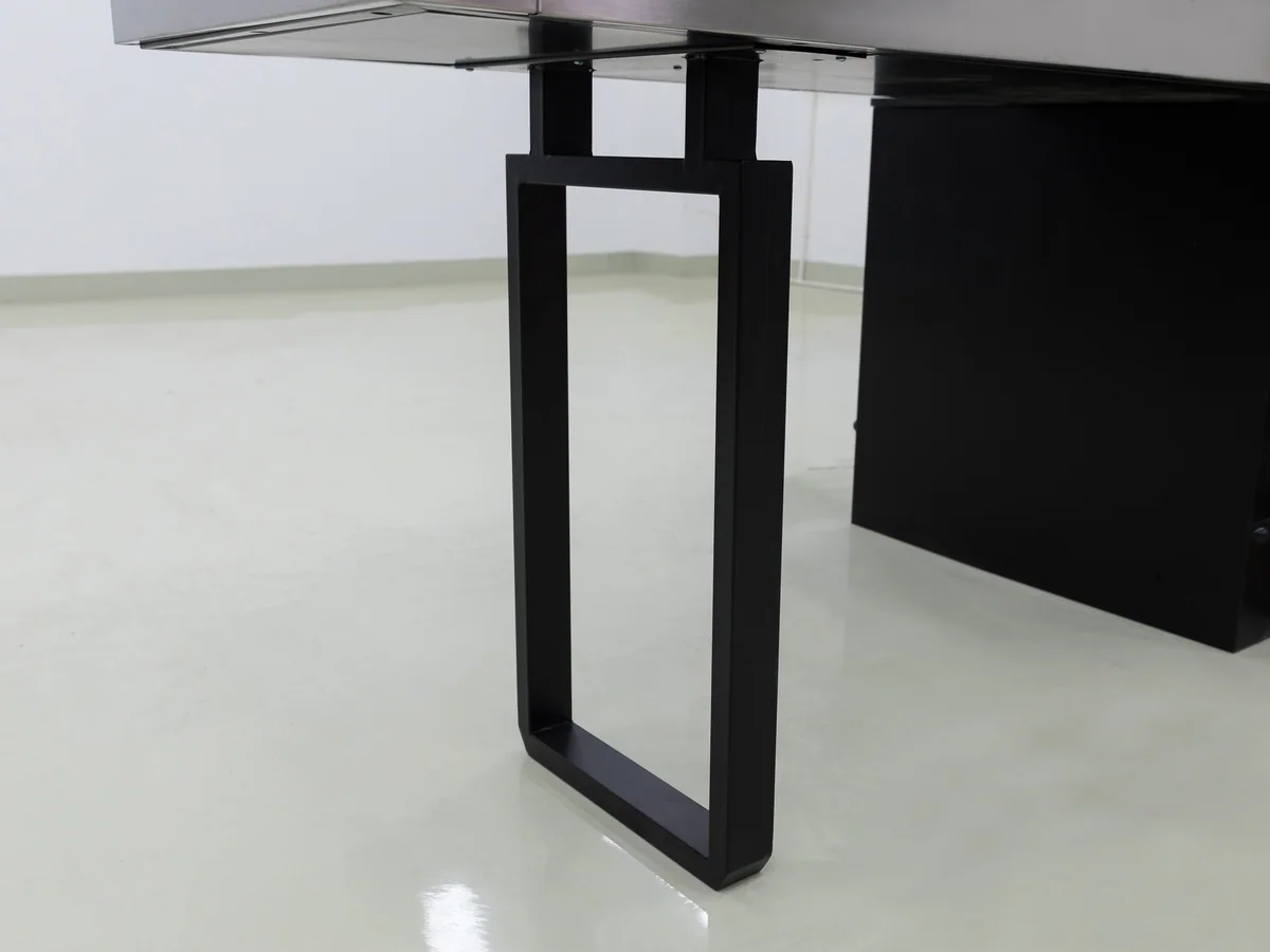 Close-up of the junction where the stainless top meets the steel frame