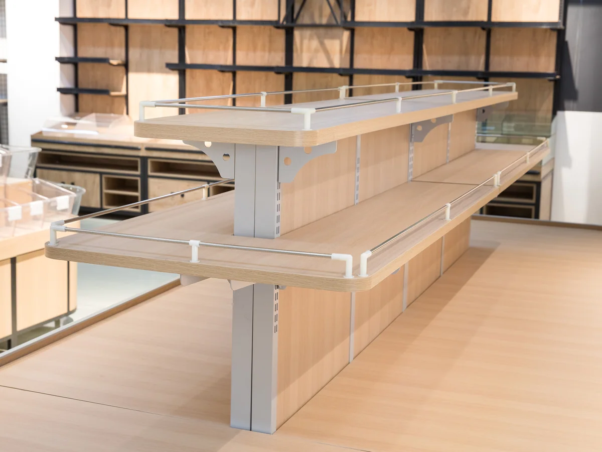 Close-up of the raised upper shelf stepping above the pale worktop deck
