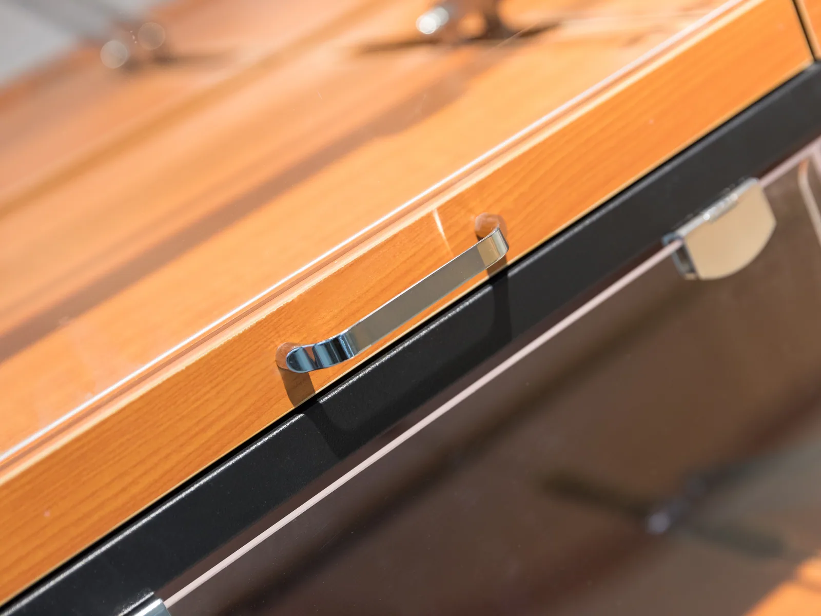 Close-up of a slanted timber tray level on a Keshun bakery bread display rack