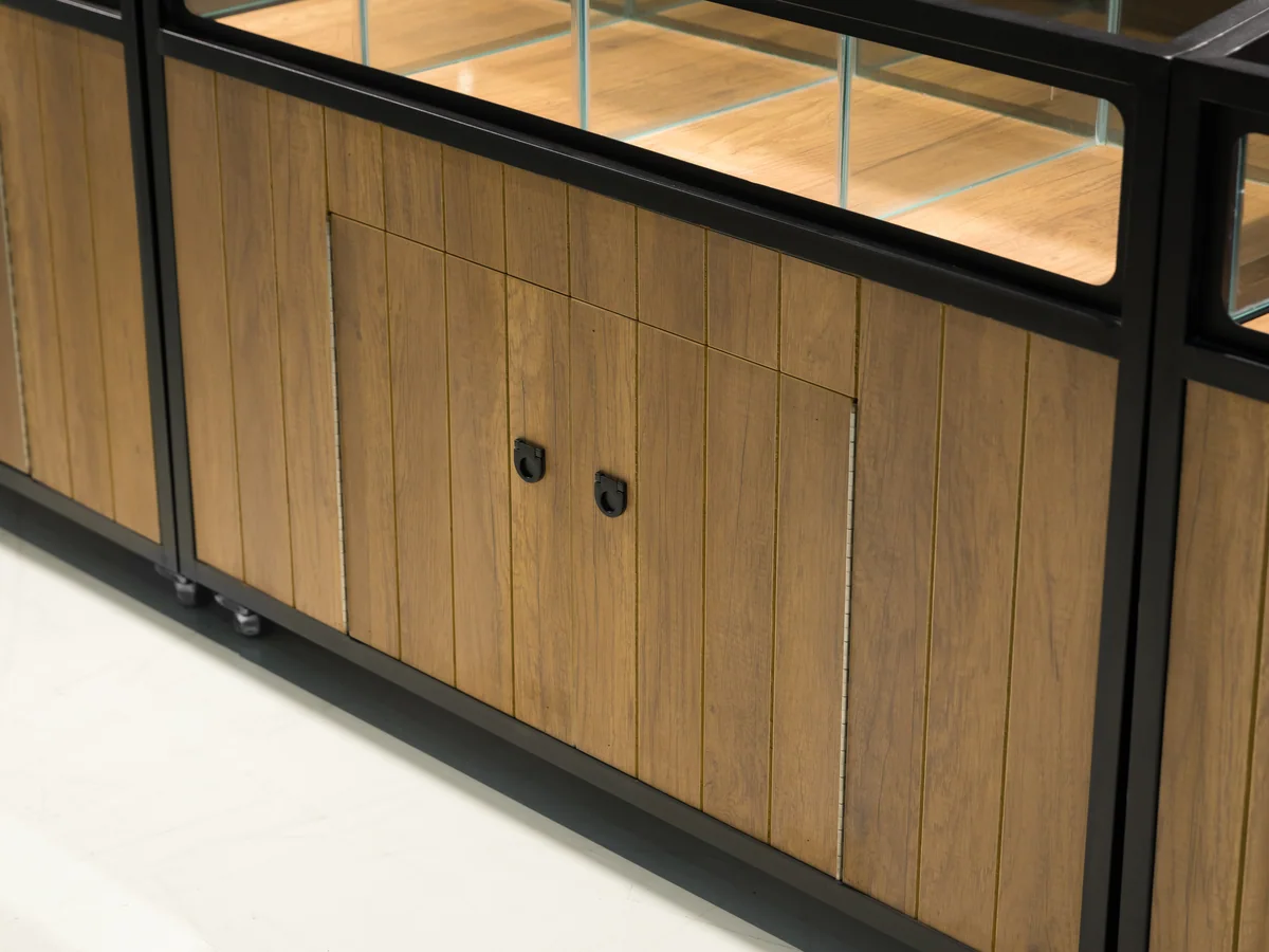 Close-up of the timber cabinet doors sitting under the black steel frame of the island