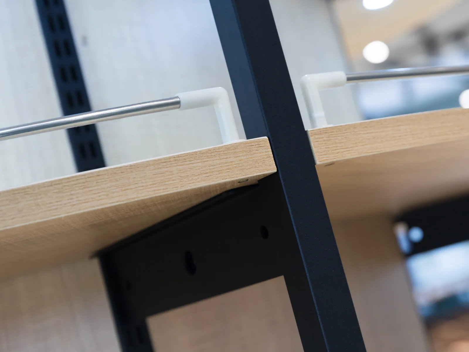 Close-up of a timber shelf meeting the steel upright on a Keshun supermarket shelving bay