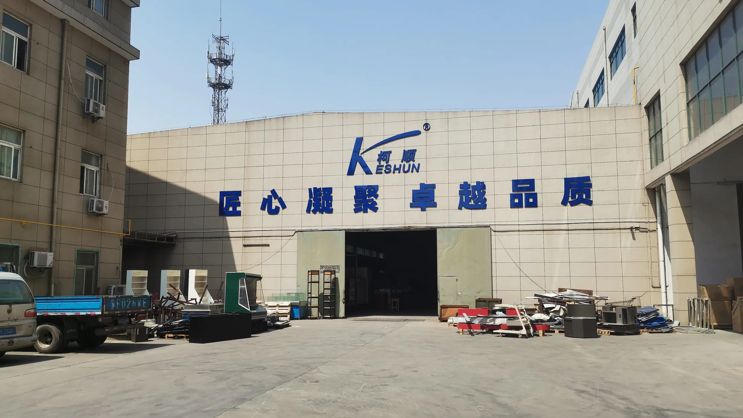 Crated and wrapped supermarket fixtures staged for export loading at the Keshun plant
