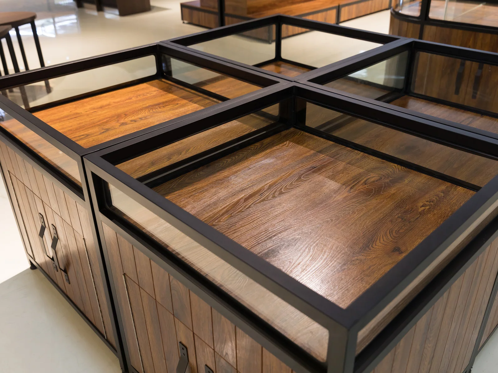 Cross braced square dry goods cabinet photographed from a corner, showing two faces and the glazed top