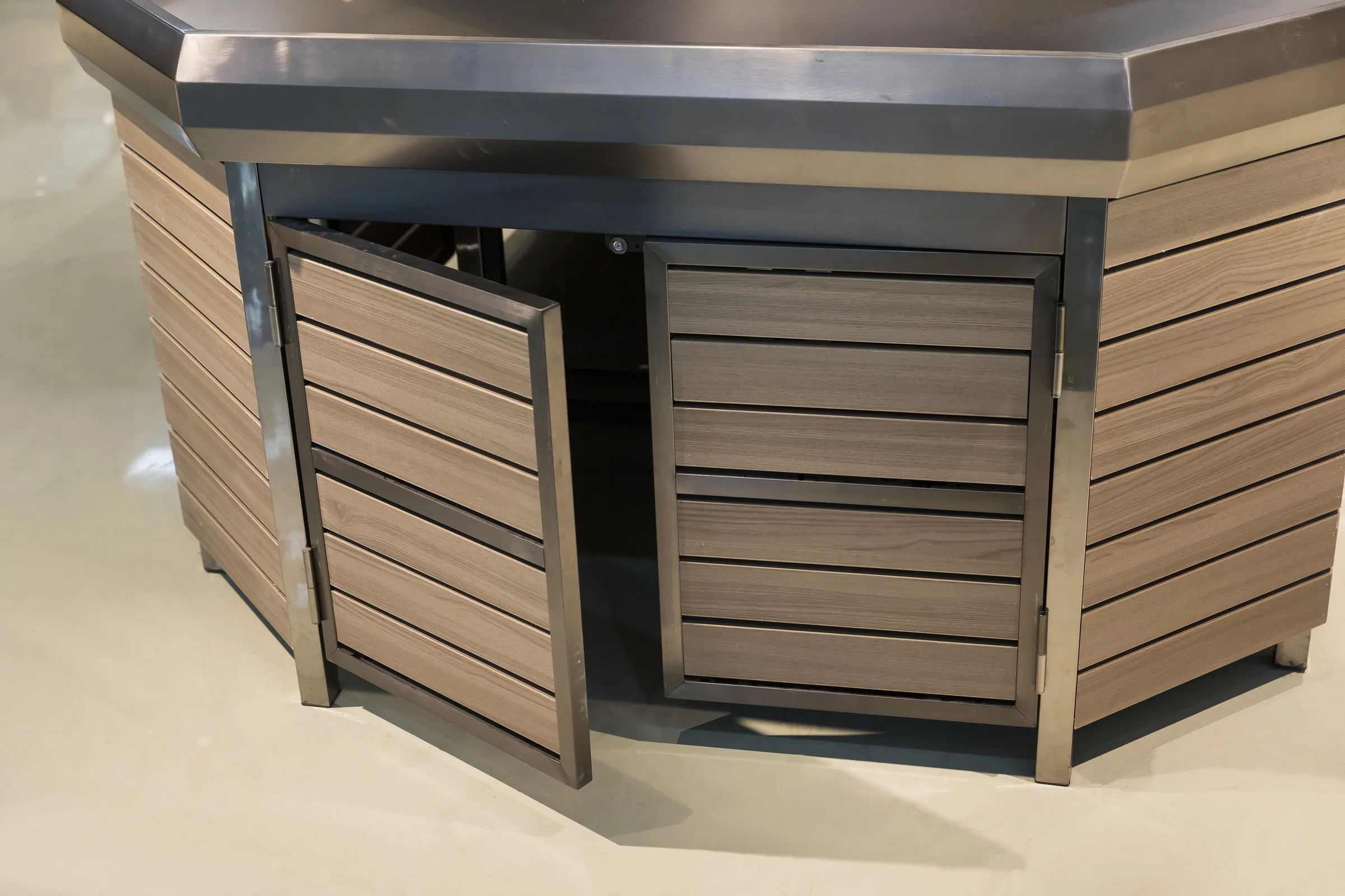 Keshun dark slatted produce island with an angled aisle head end and an overhead sign header