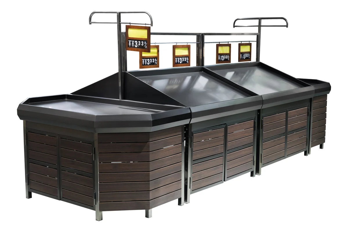 Dark timber supermarket produce island with a black deck and illuminated overhead sign panels