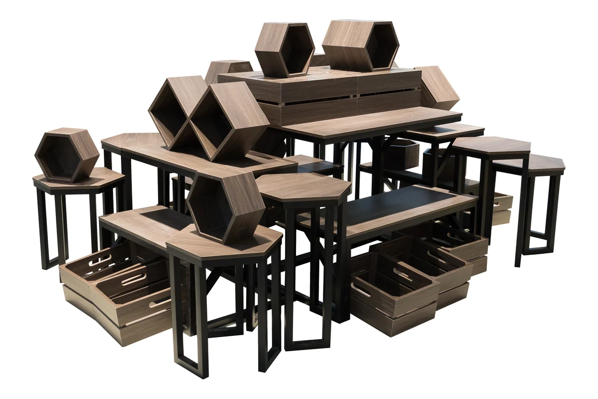 Ensemble of dark timber supermarket promotion tables, crates and hexagonal risers arranged as a set