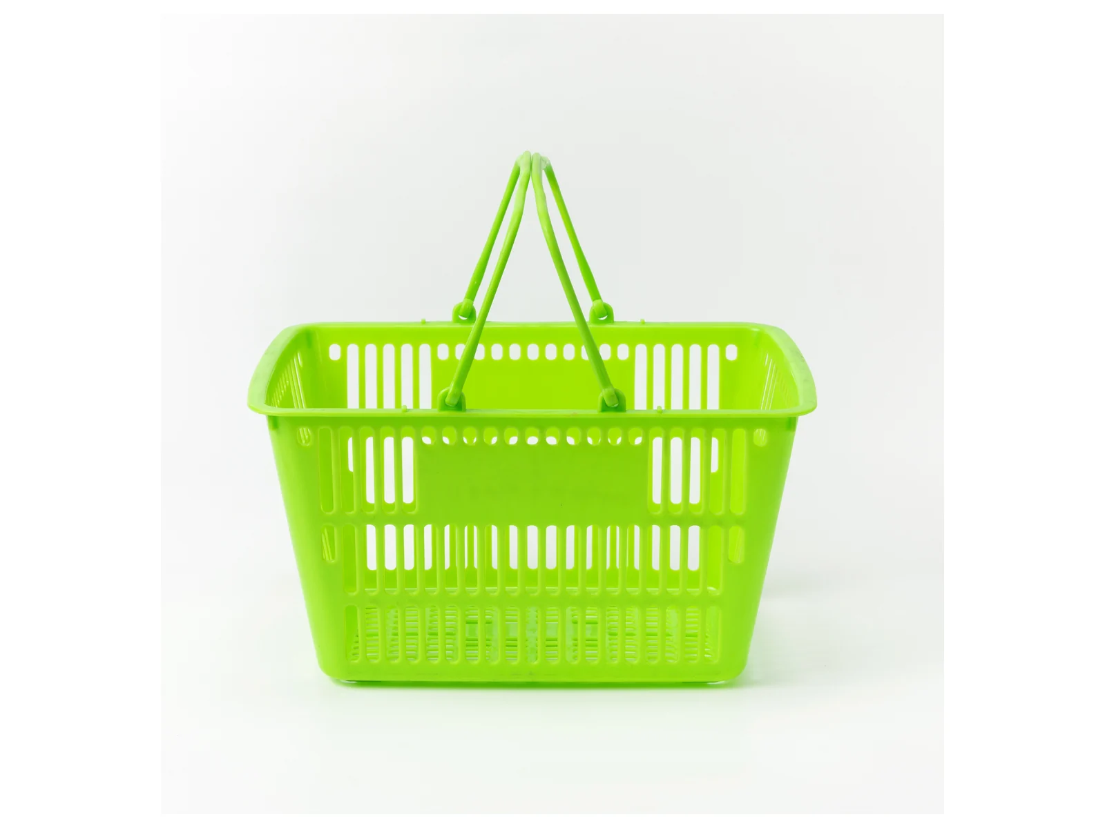 Green Hand Basket with Twin Handles photographed from the front on a white studio background