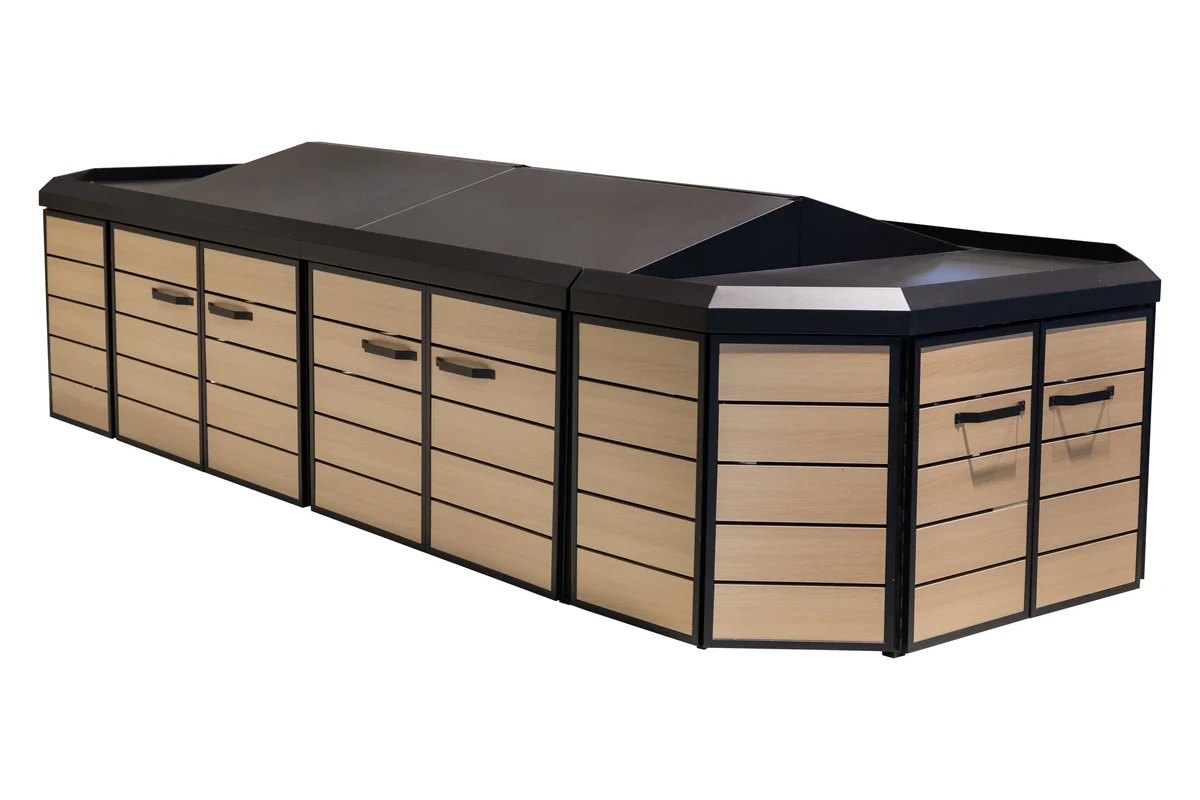 Long wooden supermarket produce island with dark canopy top and base cabinet doors on both sides