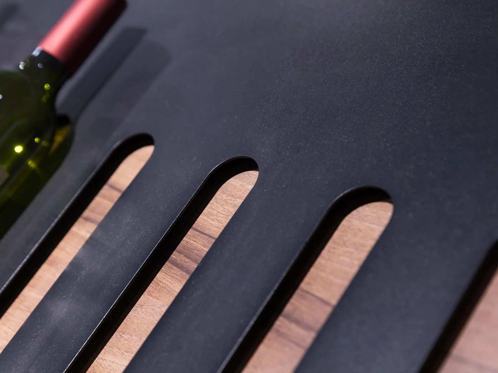 Mobile wine table photographed from an angle showing the castors and crate storage