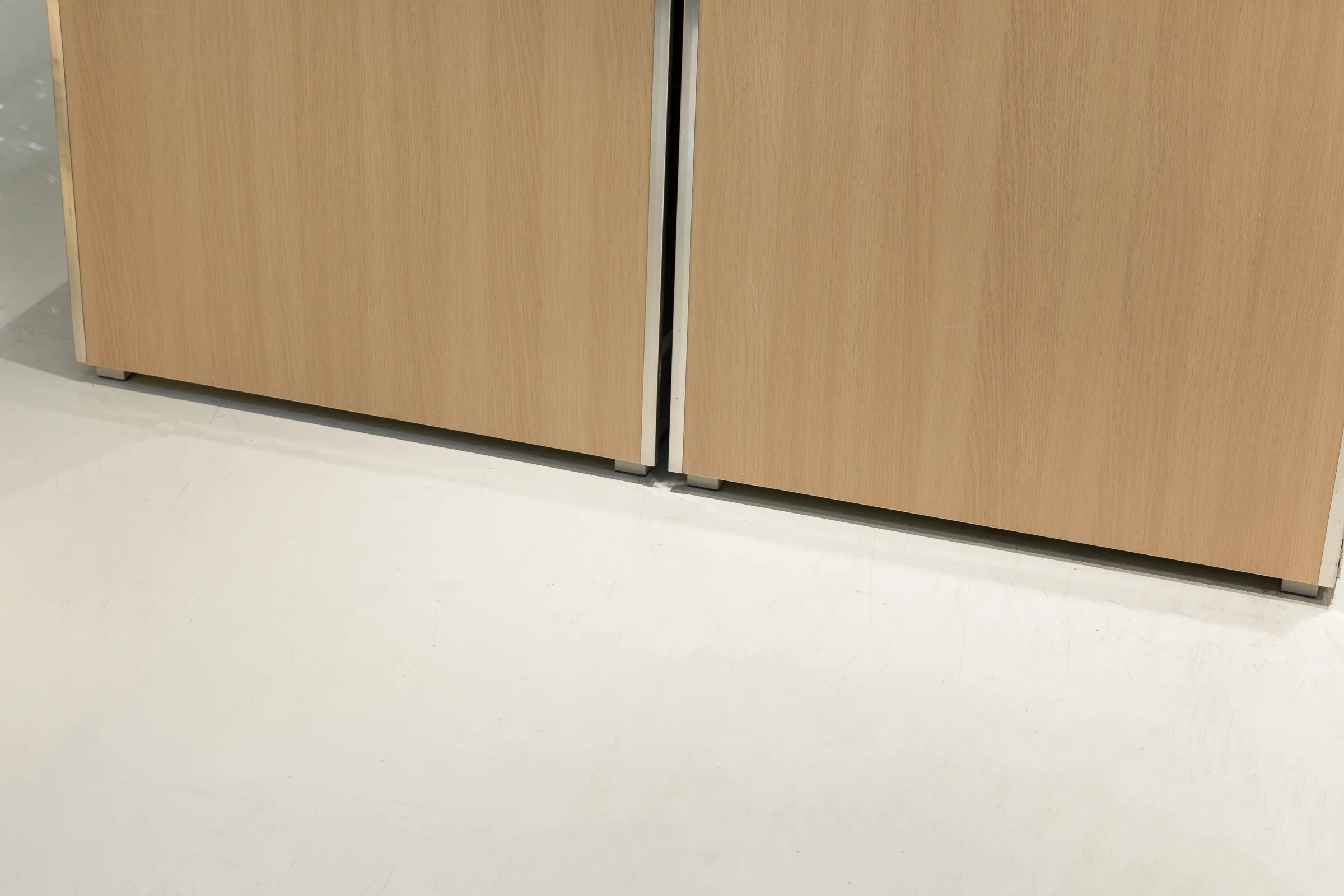 Keshun pale timber produce island topped with a grid of divided lift-out stainless trays