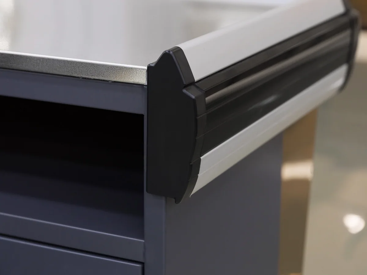 Panel split between the two powder coat colours on a Keshun cashier counter body