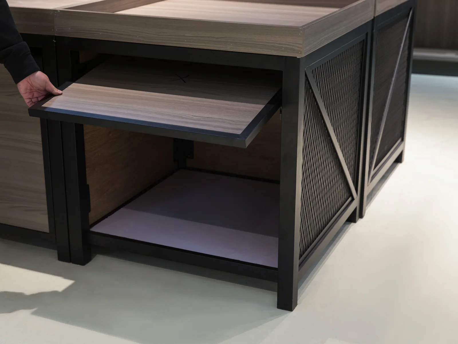 Pull out tray island photographed from a corner, showing the X braced flank and the quartered top