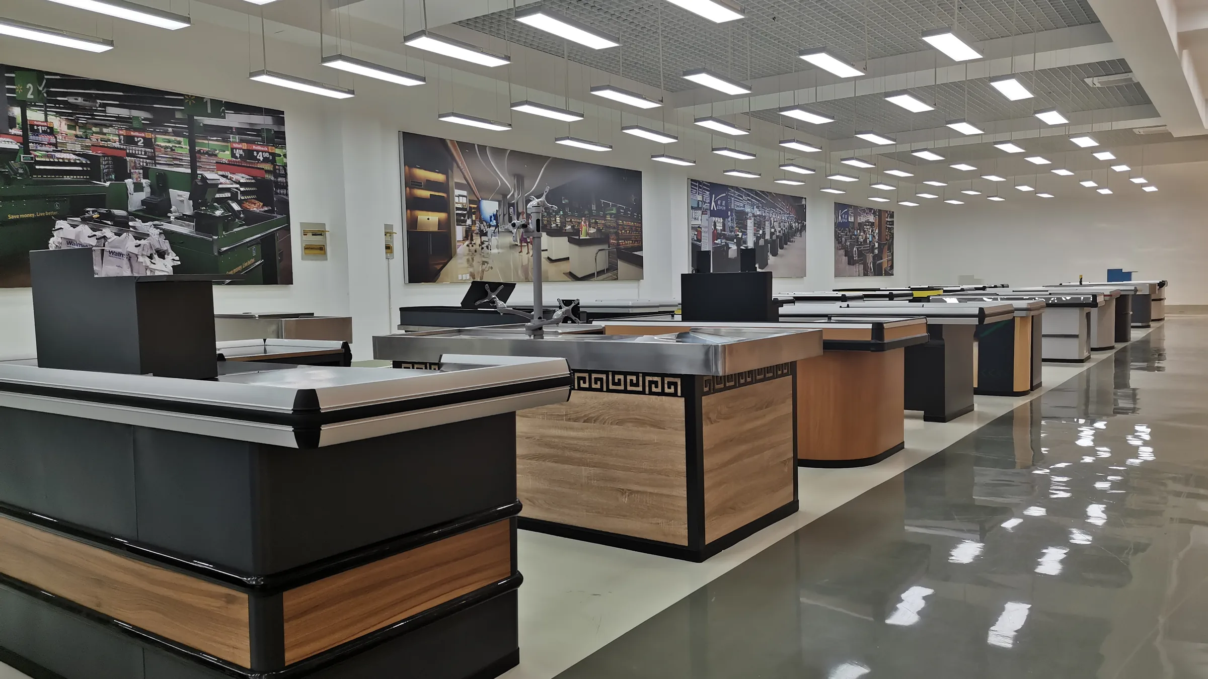 Row of Keshun checkout counters with wood fronts and stainless worktops set out in the Changshu showroom