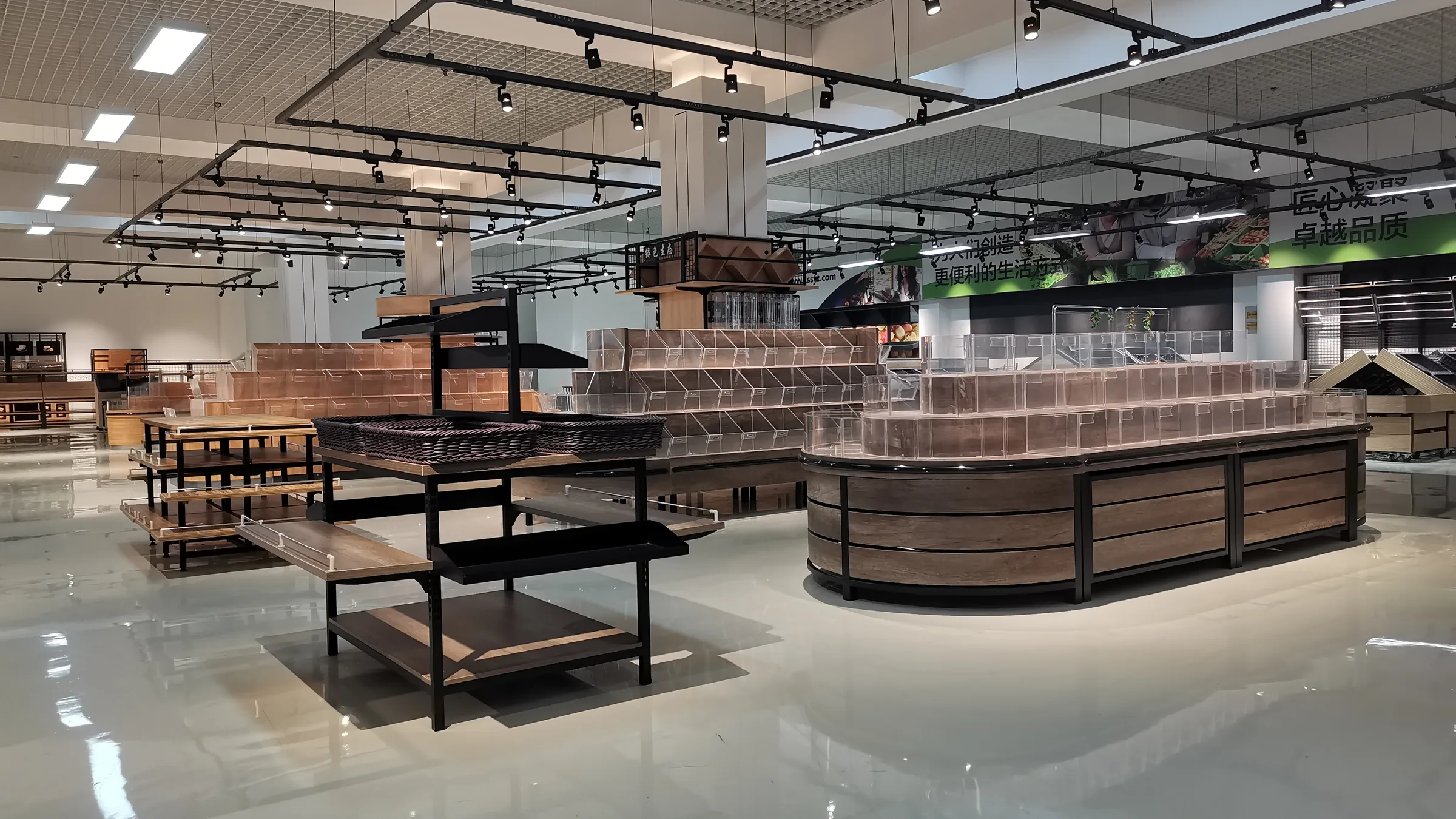 Showroom aisle of Keshun wood and steel gondola bays running alongside low produce islands