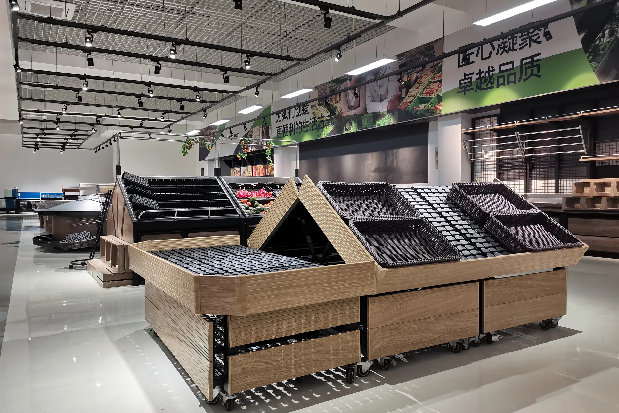 Keshun showroom aisle lined with wooden supermarket fruit and vegetable display racks under overhead signage