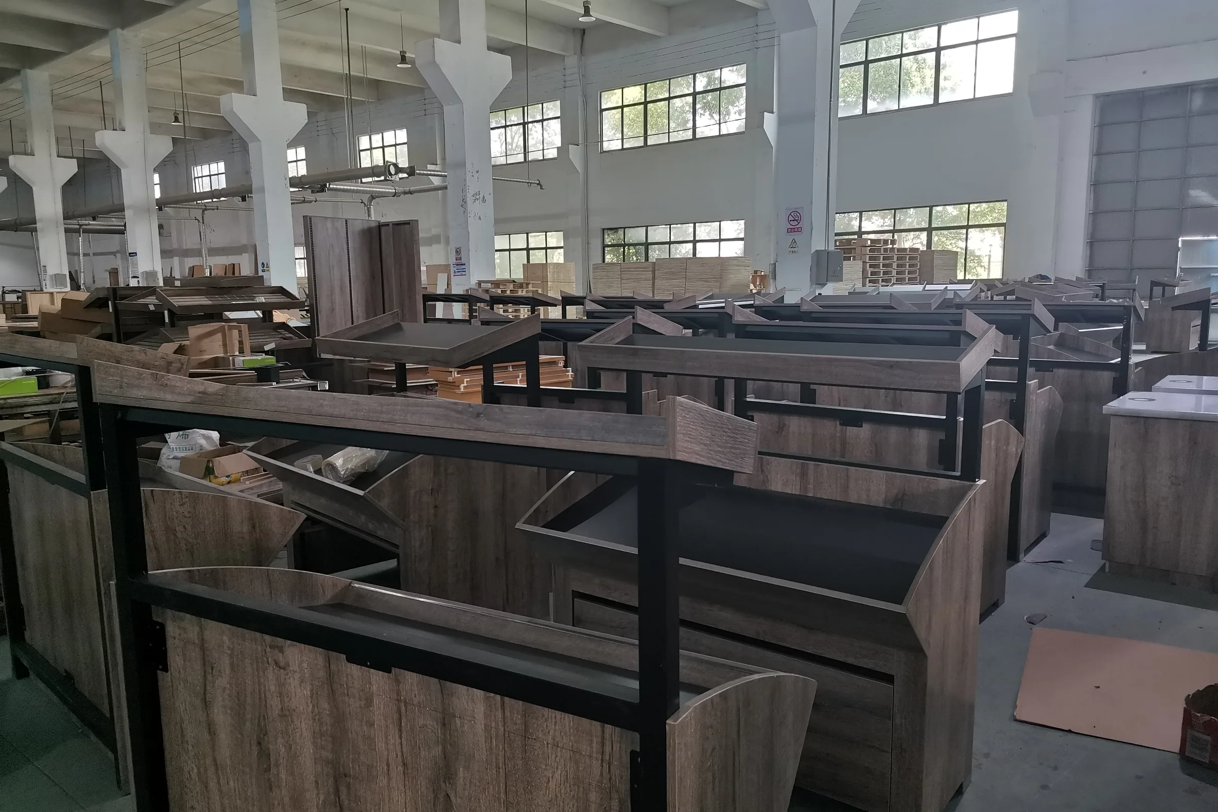 Steel and wood supermarket shelving bays standing in the Keshun production hall