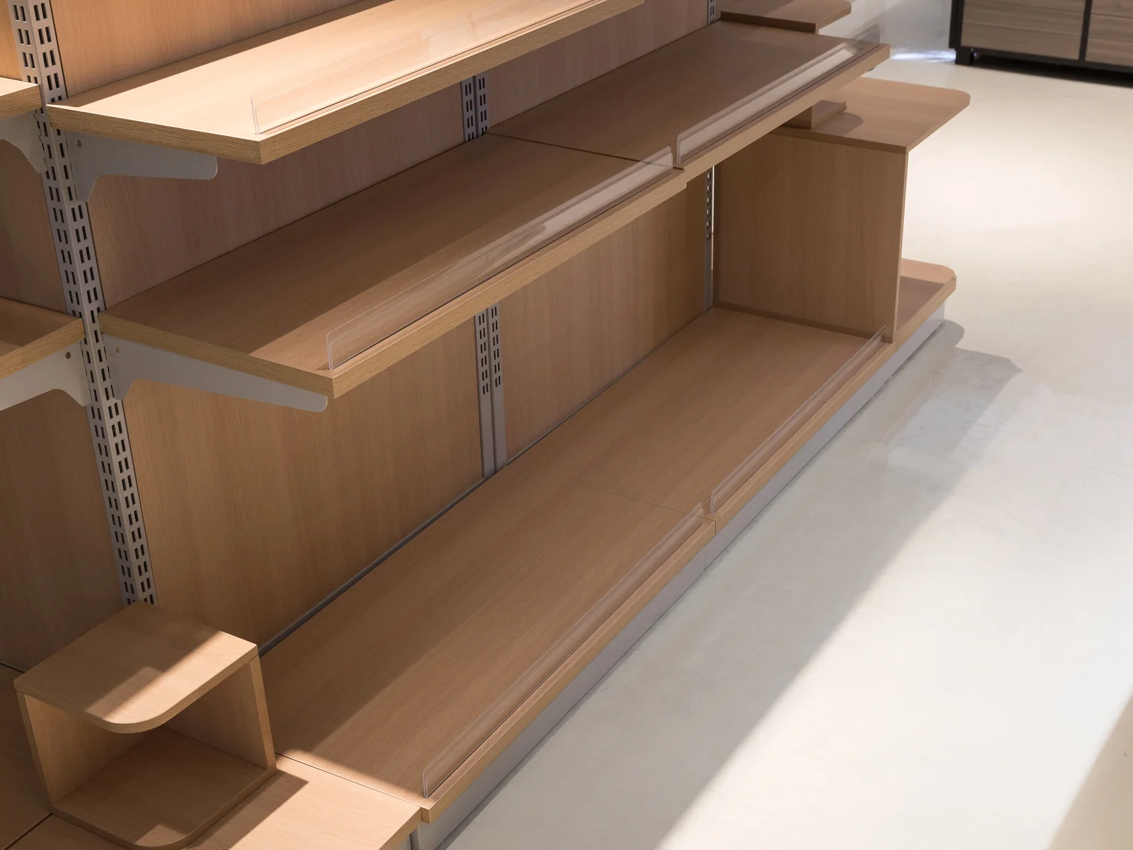 Tiered promotional display photographed from the front showing the angled shelves