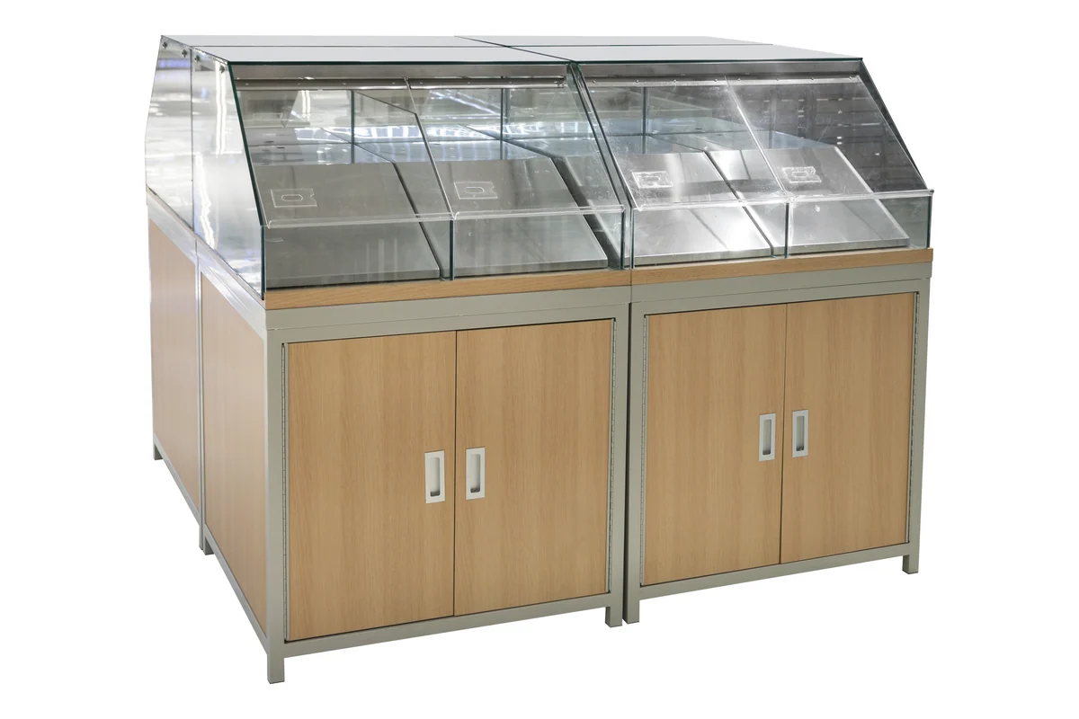 Twin angled glass bakery display cases standing side by side on a shared timber cabinet base