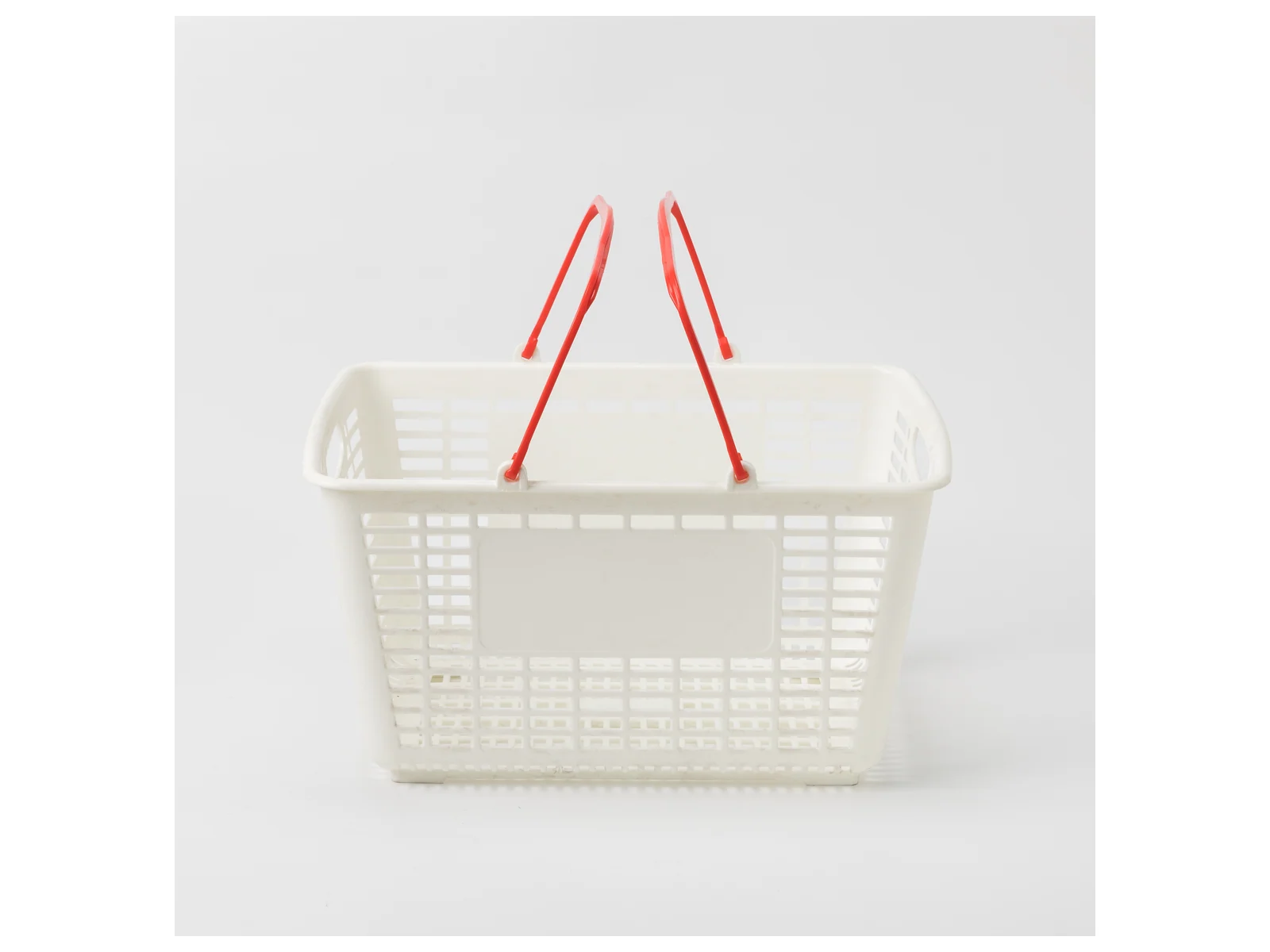 White Hand Basket with Red Handles photographed from the front on a white studio background